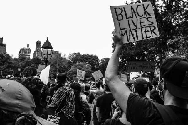 People holding signs at a Black Lives Matter protest.